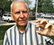 Richard Clem, holding a small silver Civil War ID badge he found while relic . (clem )