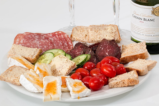 Tomatoes cucumbers bread and cheese platter