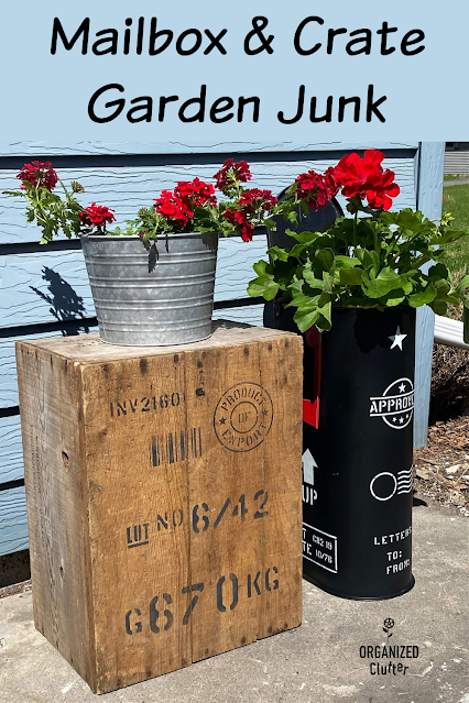 Photo of stenciled garden junk, a crate and a mailbox planter.