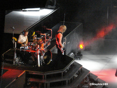 Rick Savage, Rick Allen, Def Leppard live; zoomed in from the nosebleed seats.