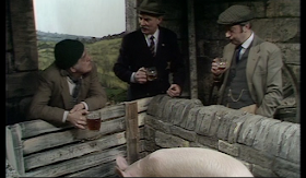 Compo, Blamire and Clegg drinking pints while standing round a pig sty. 