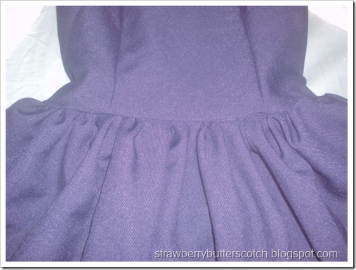 Making a cute school-like jumper style dress made with navey blue poly poplin and trimmed with crocheted lace.