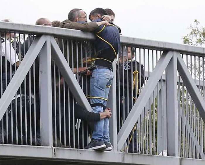 30 Heartwarming Photos That Restored Our Faith In Humanity - People Holding Onto Man Trying To Commit Suicide