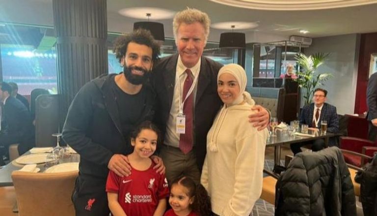 Who is actor Will Ferrell "embracing" Mohamed Salah and his wife? Pictures of the Egyptian star Mohamed Salah, the player of "Liverpool" club, and his family with actor Will Ferrell, raised many questions about the famous American comedian.  Mohamed Salah, through his account on the “Instagram” website, published several photos with the American comedian after the end of his club, “Liverpool”, with “Everton” in the English Premier League.  Will Ferrell has been seen around the UK during a 6-day tour with his friends to watch football matches across the country, and he seems to be having a great time.  Who is actor Will Ferrell? Will Ferrell is a famous American actor, writer and producer, whose full name is John William Ferrell, at the age of 55, as he was born on July 16, 1967 in California.  Ferrell grew up in Irvine, California, and participated in reading morning ads in high school using a variety of voices, which showed his comedic skills.  Ferrell later studied sports journalism at the University of Southern California in Los Angeles, and after graduating in 1990 he worked as a local sportscaster before studying acting and comedy.  Will Ferrell began his career in comedy as a member of the LA-based improv group The Groundlings, and after a year of training with them he became a member of the company.  In 1995 he was invited to join the television sketch show Saturday Night Live (SNL), and after a while he became a regular member of it.  According to Britannica, Ferrell was known to imitate famous people, notably game show host Alex Trebek, sportscaster Harry Caray, and former US President George W. Bush.  While on SNL, Ferrell also appeared in feature films such as: James Bond parody Austin Powers: International Man of Mystery (1997), Dick (1999), and a satire of the "Watergate" scandal.  In 2002, Ferrell left SNL to focus on a film career, and began collaborating with Adam McKay, a writer-director he met on SNL. The following year, Will Ferrell took the lead in Elf (2003), playing a charmingly naive human who grows up in Santa's Village and ventures to New York City, which was a box office success.  He then starred in a string of successful comedies, notably Anchorman: The Legend of Ron Burgundy (2004) and NASCAR spoof Talladega Nights: The Ballad of Ricky Bobby (2006), both of which he wrote with Adam McKay.  In 2005, Ferrell played a Nazi playwright in the musical comedy The Producers, and played equally bizarre characters in the sports comedies Blades of Glory (2007) and Semi-Pro (2008).  Although most of Ferrell's film work has been comedies, he has occasionally taken on more serious roles, including a methodical Internal Revenue Service agent in Stranger than Fiction (2006) and an alcoholic selling his possessions in Everything Must Go (2010).  By 2006, Ferrell and Adam McKay launched Gary Sanchez Productions, producing several films starring Ferrell, including the comic Step Brothers (2008), the buddy parody The Other Guys (2010), and others.  The production company was also behind Funny or Die (funnyordie.com), a website first made popular by a short video clip of Ferrell being bullied by his housewife, a drunken toddler.  According to the site, among Ferrell's most prominent works are: "You're Welcome America," and "A Final Night with George W. Bush."  Inspirational situations in the life of Will Ferrell Biography states that Will Ferrell used his comedic skills for noble philanthropic causes. In 2009, he launched a series of sunscreen lotions, which appeared on the bottle in minimal clothing alongside titles such as Sexy Hot Tan and Forbidden Fruit, and channeled all proceeds from sales to the Cancer Scholarship Fund. College Willpowered.  A longtime sports fan, Ferrell was also involved with another Cancer for College charity playing on 10 big league baseball over the course of one spring training day in 2015, and the following year he joined the Los Angeles Football Club's ownership group. Which also includes former athletic greats Magic Johnson and Mia Hamm.