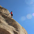 Man climbing sloping mountain