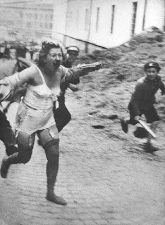 Jewish woman chased by men and youth armed with clubs during the Lviv pogroms, July 1941