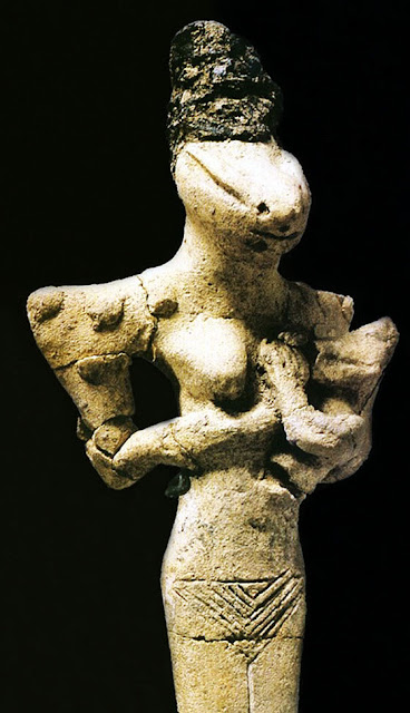 Snake head Goddes or Female figure, Feeding her Baby - terracotta, circa 5000-4000 BC, from Ubaid period before the Sumerians - at the Iraq Museum, Baghdad