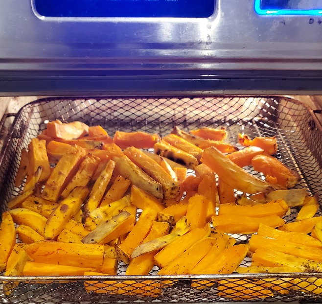 sweet potato fries cooking in the air fryer