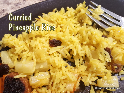 Photo shows Curried Pineapple Rice on brown dinner plate.