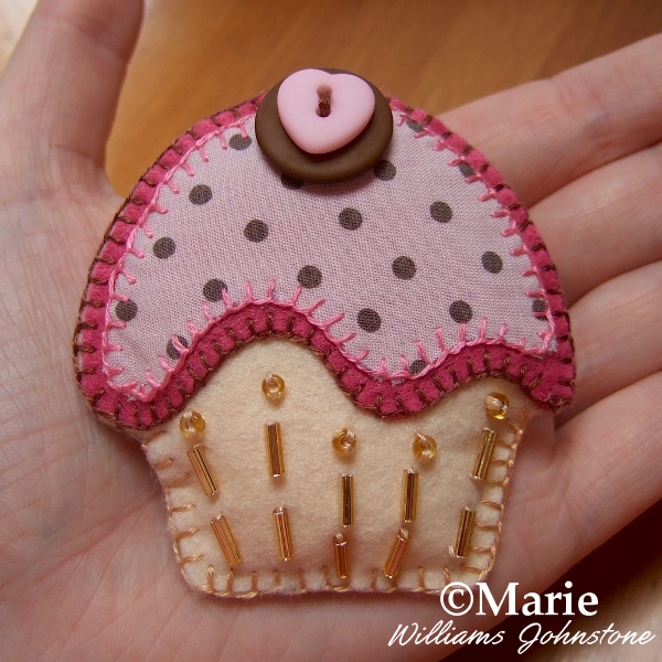 Pink and brown felt and fabric cupcake brooch pin with button and bead details