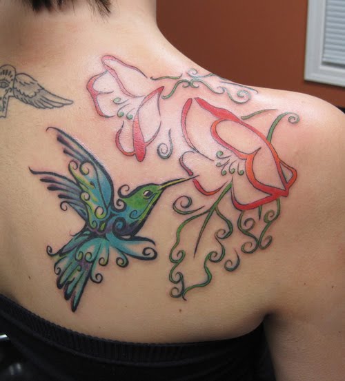 Tattoo tribal style hummingbird and flowers