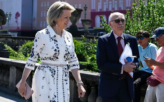 Queen Mathilde wore a Kasia floral print cotton midi shirt dress by Erdem. Rosa gemstone drop earrings