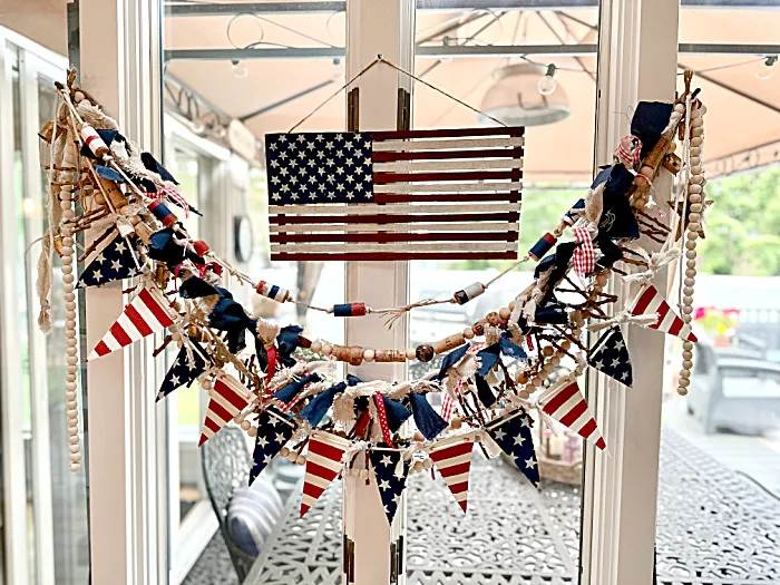 flag hanging in window with banners and garlands