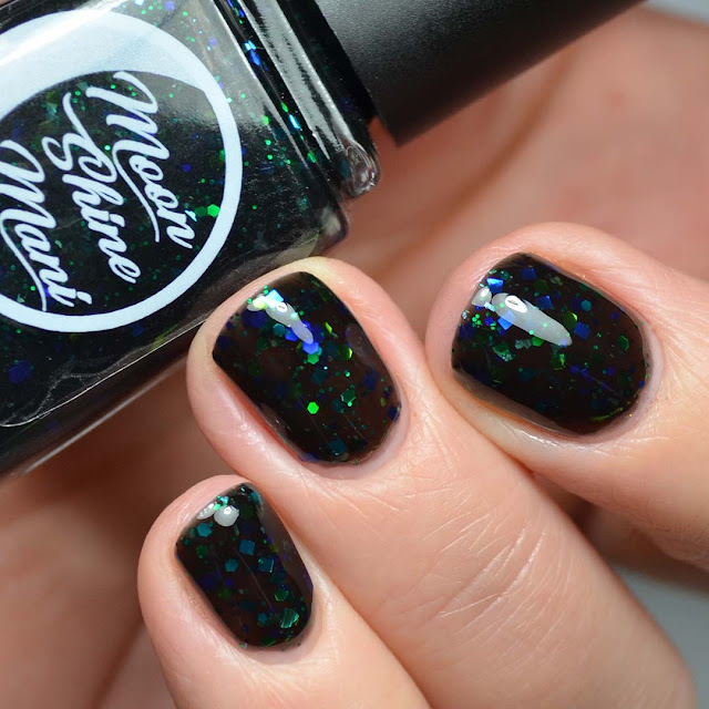 black jelly nail polish with black and green glitter swatch