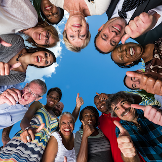diverse happy people giving thumbs up
