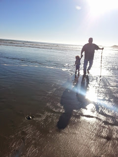 grandpa and tray walking on beach