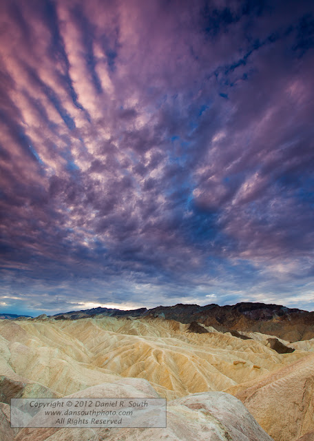 a fine art photograph of zabriskie point at sunrise on a cloudy morning