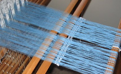 A few picks woven in behind the heddles.