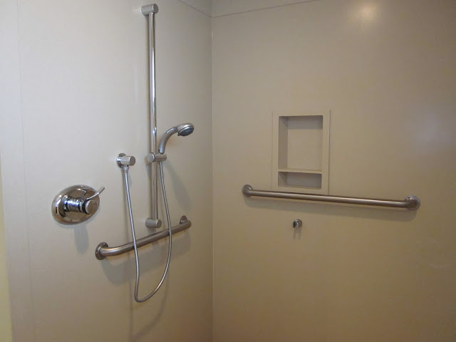 a stainless steel bathroom safety bars in the white wall