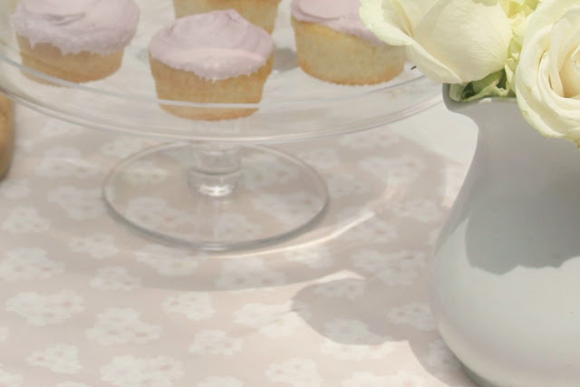 Glass cake pedestal with pink frosted cupcakes - Hello Lovely Studio