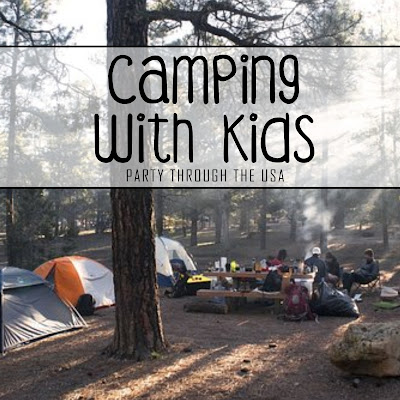 Picture of a family camping with text overlay saying "Camping with Kids."