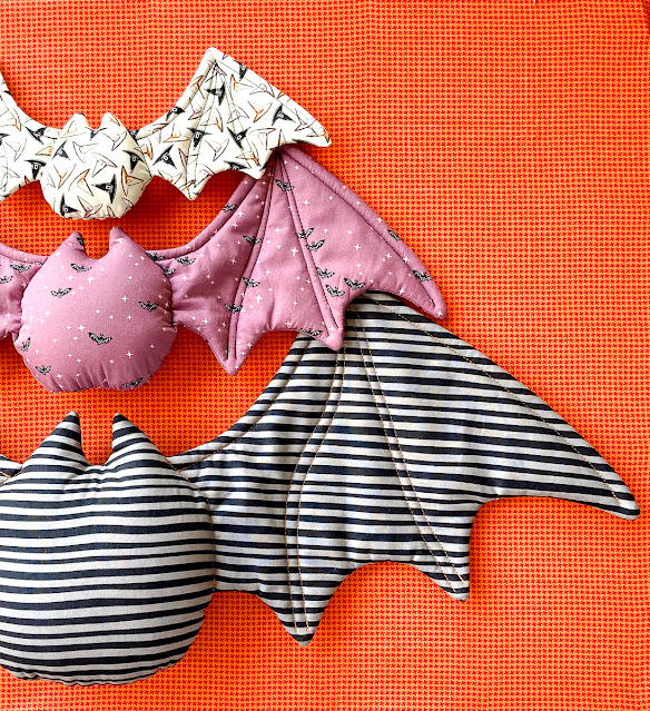 Halloween bats in 3 sizes on orange backround