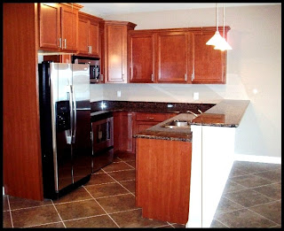 Note the large tile on the diagonal and stainless appliances