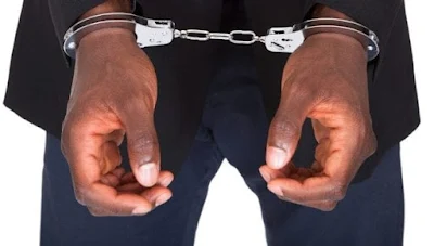 A man on handcuffs after being arrested