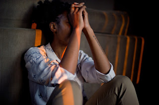 A woman stressed out sitting on a sofa