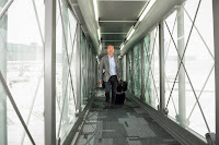 The first passenger arrives to board a Qatar Airways plane in Doha, Qatar, on Wednesday, April 30, 2014 as the new airport opened.