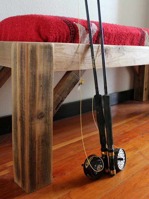 a rustic Montana bench made from reclaimed wood and a thrift store blanket