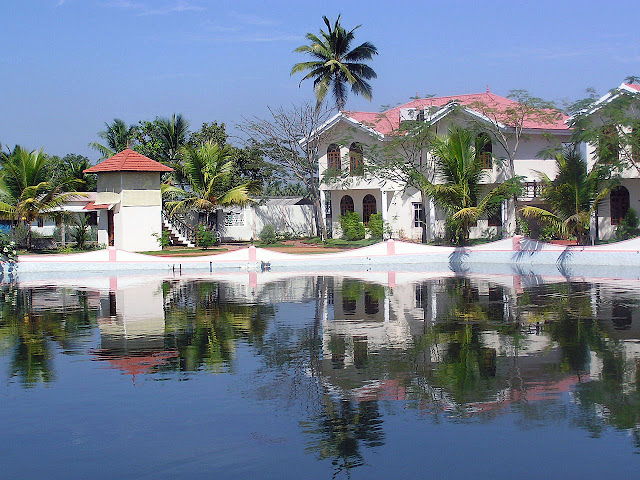 View of the cottages inside the Lake View Resort in Alleppey, with a water body right next door