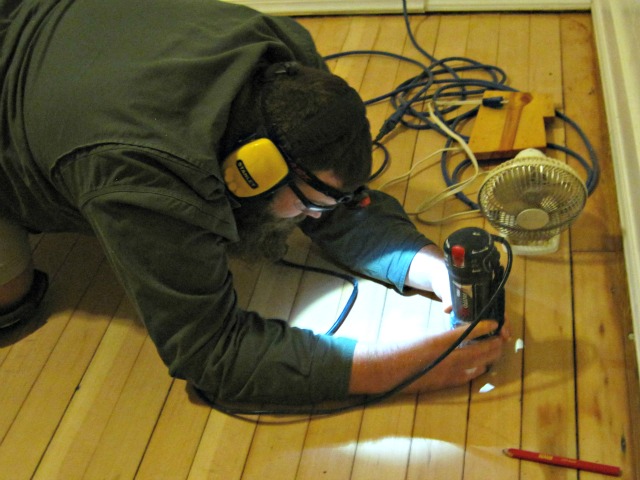 Man using roto zip tool: Repair hole in hardwood floor tutorial