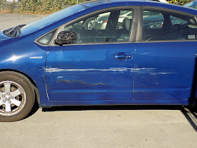 Creased fender, doors & broken mirror before collision repairs at Almost Everything Auto Body.