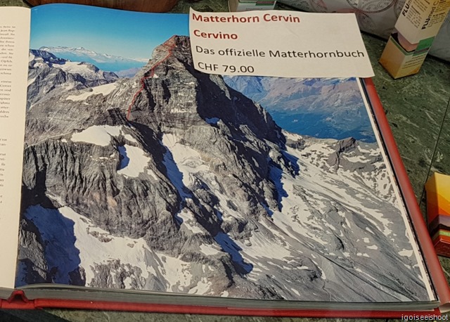 A book at a store in Zermatt with interesting picture of the Matterhorn, as viewed from the Italian side. It also shows the route of the first successful ascent team from that side on 17 July 1865.