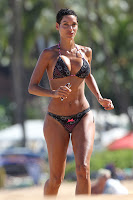 Nicole Murphy running on the beach in a bikini