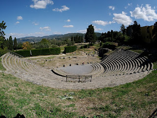 The remains of a Roman theatre on a hillside near the town of Fiesole in Tuscany