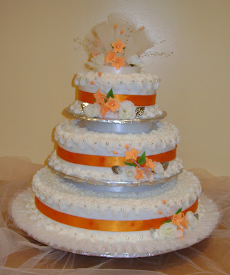 A beautiful orange and white threetier wedding cake created for an African