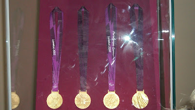 Some of the real medals, turned so you can see both sides.