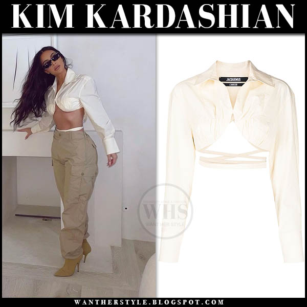 Kim Kardashian in white cropped top, khaki pants and boots