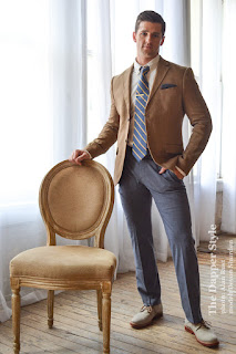 Devon Shurden wearing a blazer modeling by a antique chair