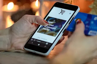 A phone screen showing a shopping app while a person is checking it