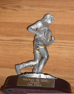 Close up picture of my trophy - it is a silver lady jogging and says Gateway 5k 2010. Overall second place