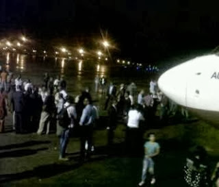 Photos of Angry Arik Air passengers blocking Abuja airport runway