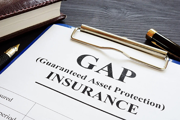 A person holding a car key and a document, symbolizing the process of unlocking information about gap insurance coverage. Exploring ways to determine if you have gap insurance.