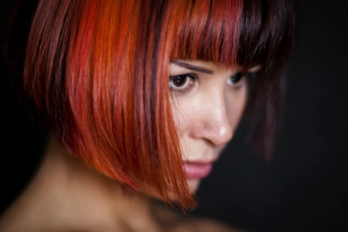 close-up portrait of a red-haired woman with a bob haircut