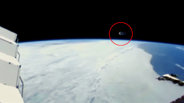 A look at the UFO Orb putting the ISS under surveillance while it's hovering next to it.