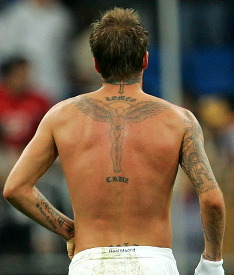tattoos on his back, arms 