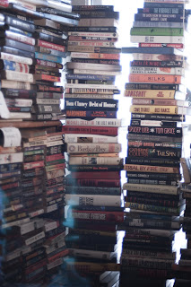 books, pile, stack, mess, bookstore, window, light, backlit, cozy