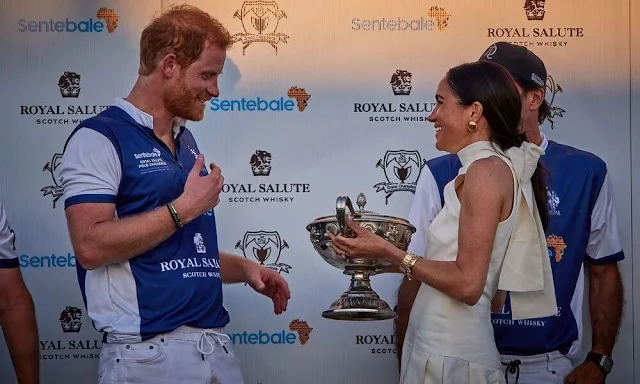 Meghan Markle, Duchess of Sussex wore an ivory silk ginger dress by Heidi Merrick at the Royal Salute Polo Challenge